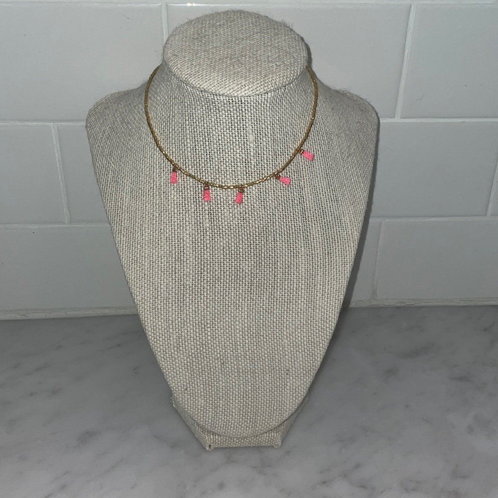 Gold choker with mini tassels.